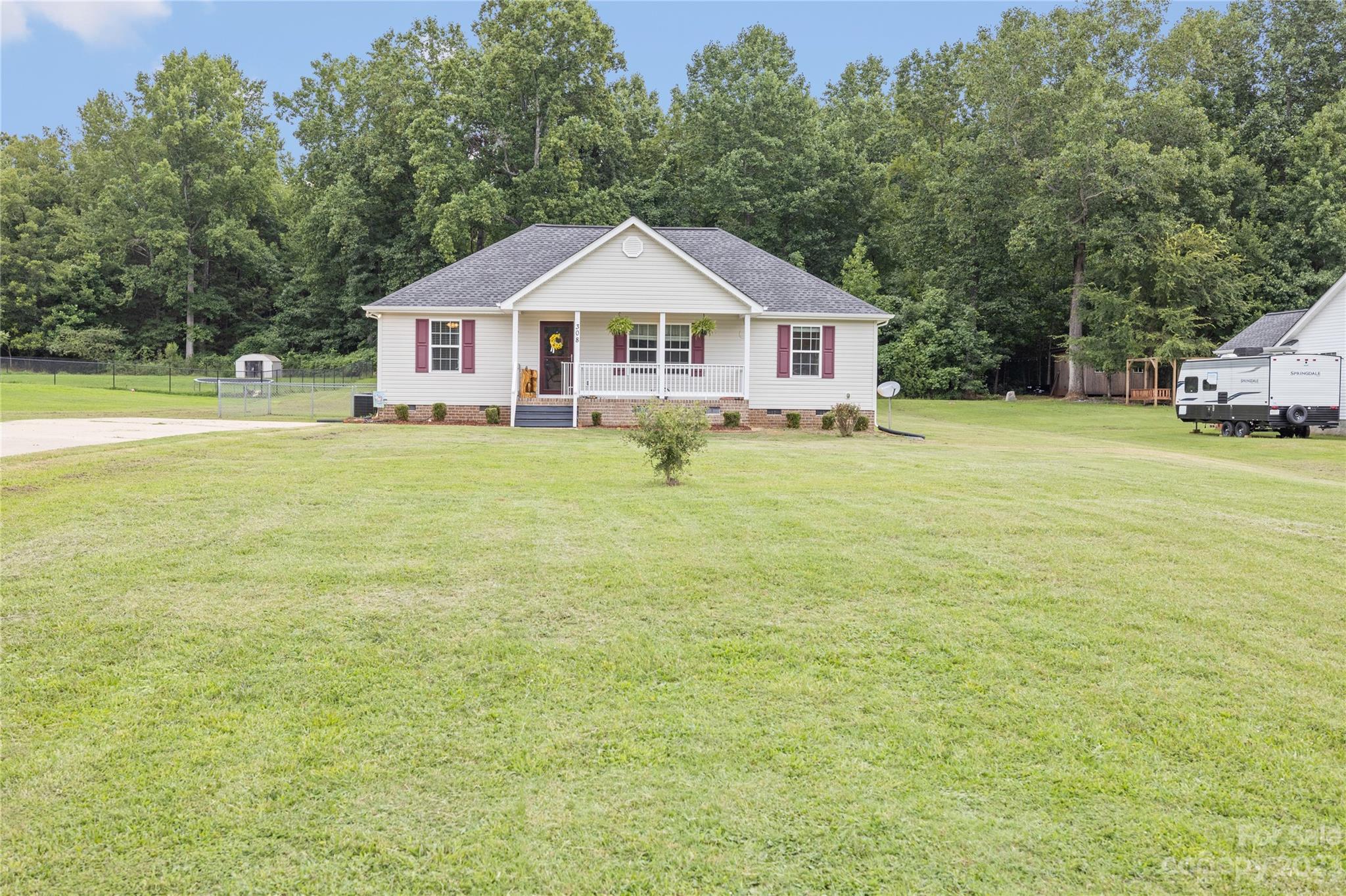 308 Fleetwood Road York, SC 29745 - Photo 2 of 25 a front of a house with a garden