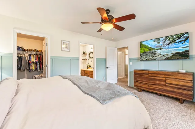 a bedroom with a bed dresser and a window