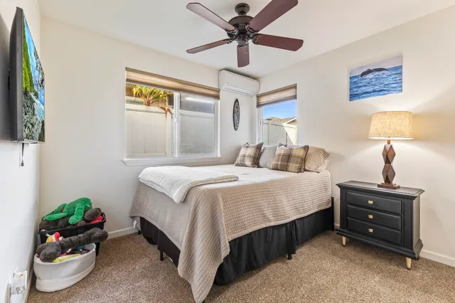 a bedroom with a large bed and a chandelier