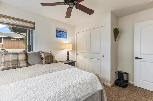 a bathroom with a granite countertop sink toilet and a mirror
