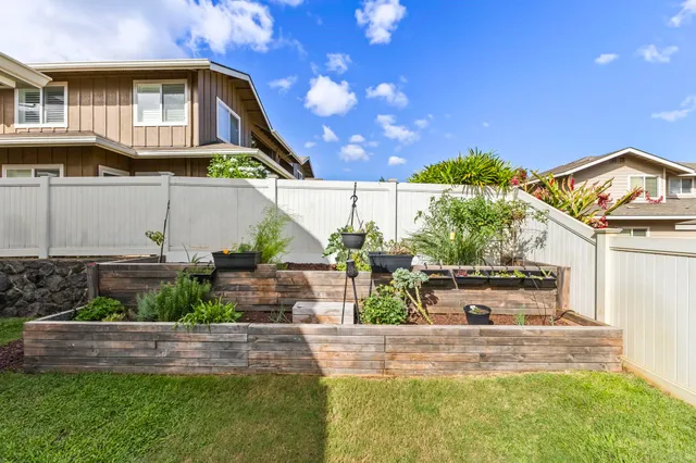 a view of a house with a yard and sitting area