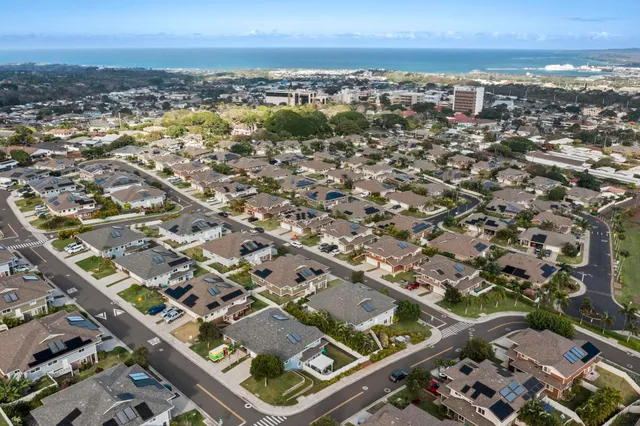 an aerial view of residential houses with city view