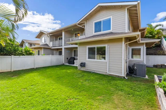 a view of a house with a backyard