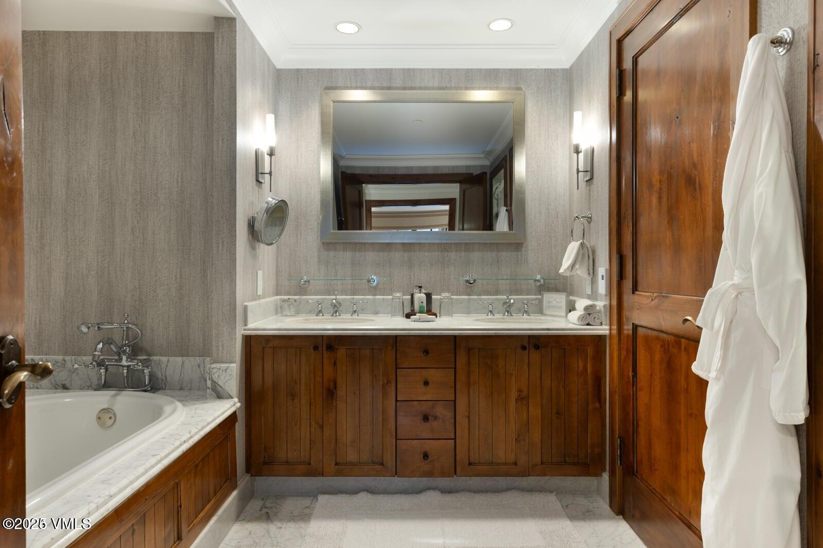 100 Bachelor Ridge Road, Unit 33146 Avon, CO 81620 - Photo 11 of 16 a bathroom with a double vanity sink mirror and bathtub
