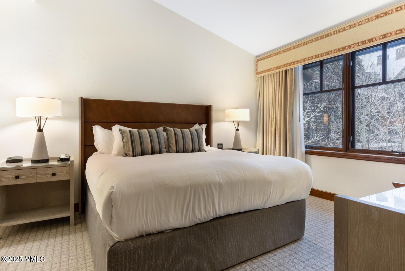 100 Bachelor Ridge Road, Unit 33146 Avon, CO 81620 - Photo 12 of 16 a bedroom with a bed and a night stand