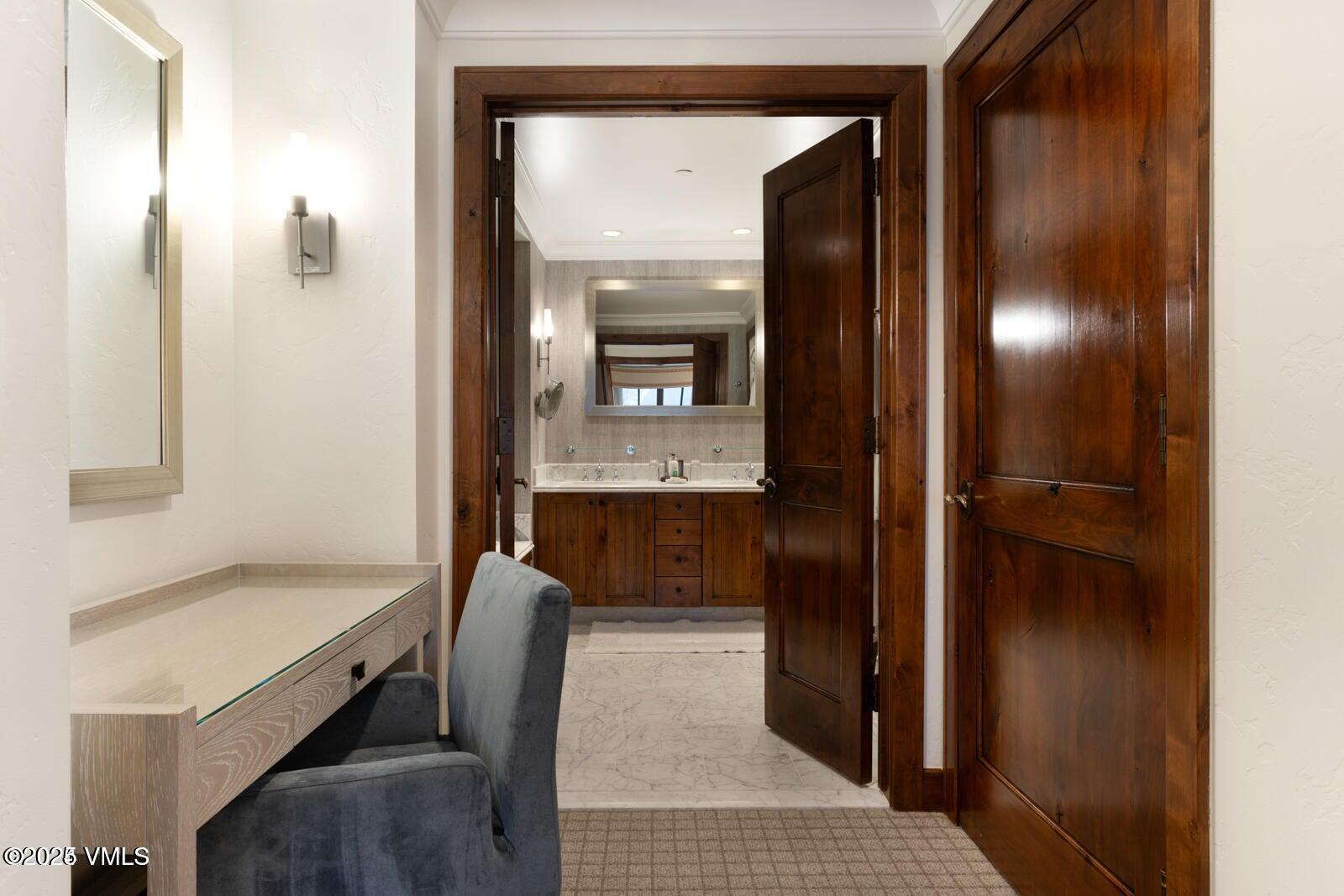 100 Bachelor Ridge Road, Unit 33146 Avon, CO 81620 - Photo 14 of 16 a en suite bathroom with a sink and a mirror