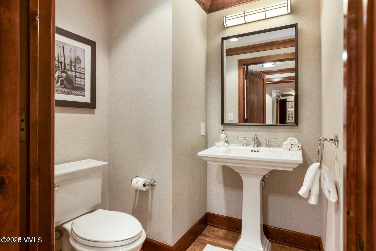100 Bachelor Ridge Road, Unit 33146 Avon, CO 81620 - Photo 16 of 16 a bathroom with a toilet a sink and mirror