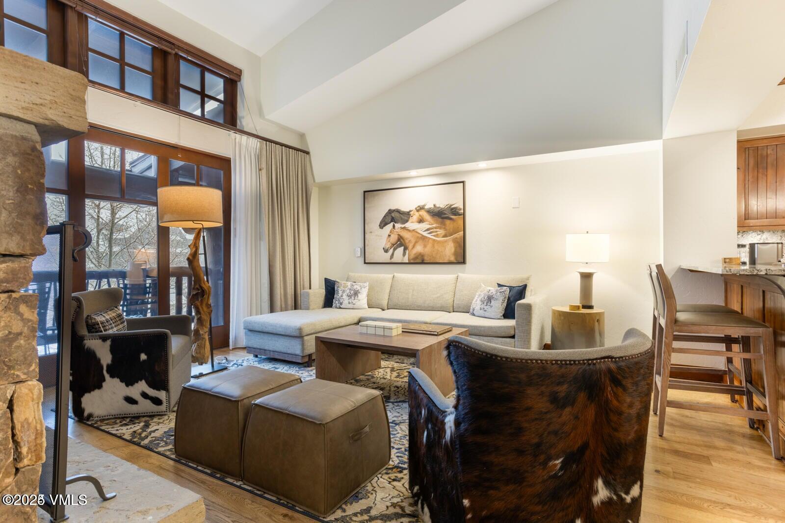 100 Bachelor Ridge Road, Unit 33146 Avon, CO 81620 - Photo 4 of 16 a living room with fireplace furniture and a potted plant