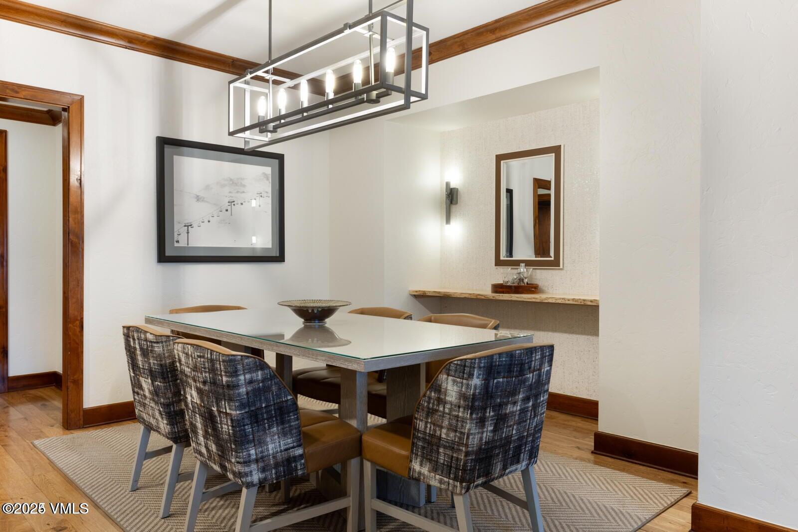 100 Bachelor Ridge Road, Unit 33146 Avon, CO 81620 - Photo 6 of 16 a dining room with a wooden table and chairs