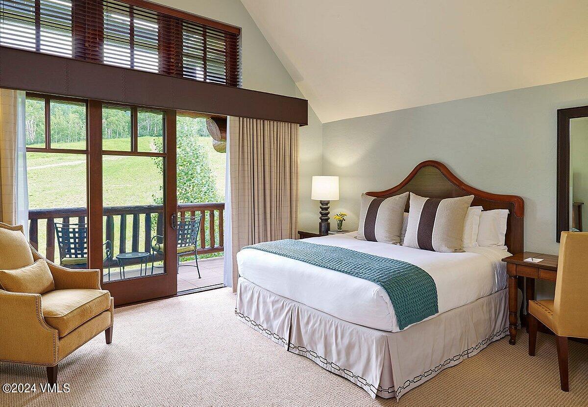 100 Bachelor Ridge Road, Unit 33146 Avon, CO 81620 - Photo 10 of 16 a spacious bedroom with a bed a couch and a large window