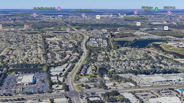 an aerial view of residential houses with outdoor space and river