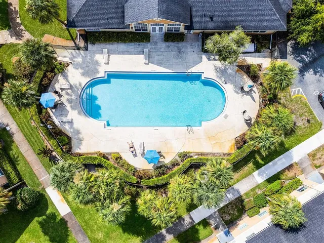 a view of a hallway with a glass door and shower