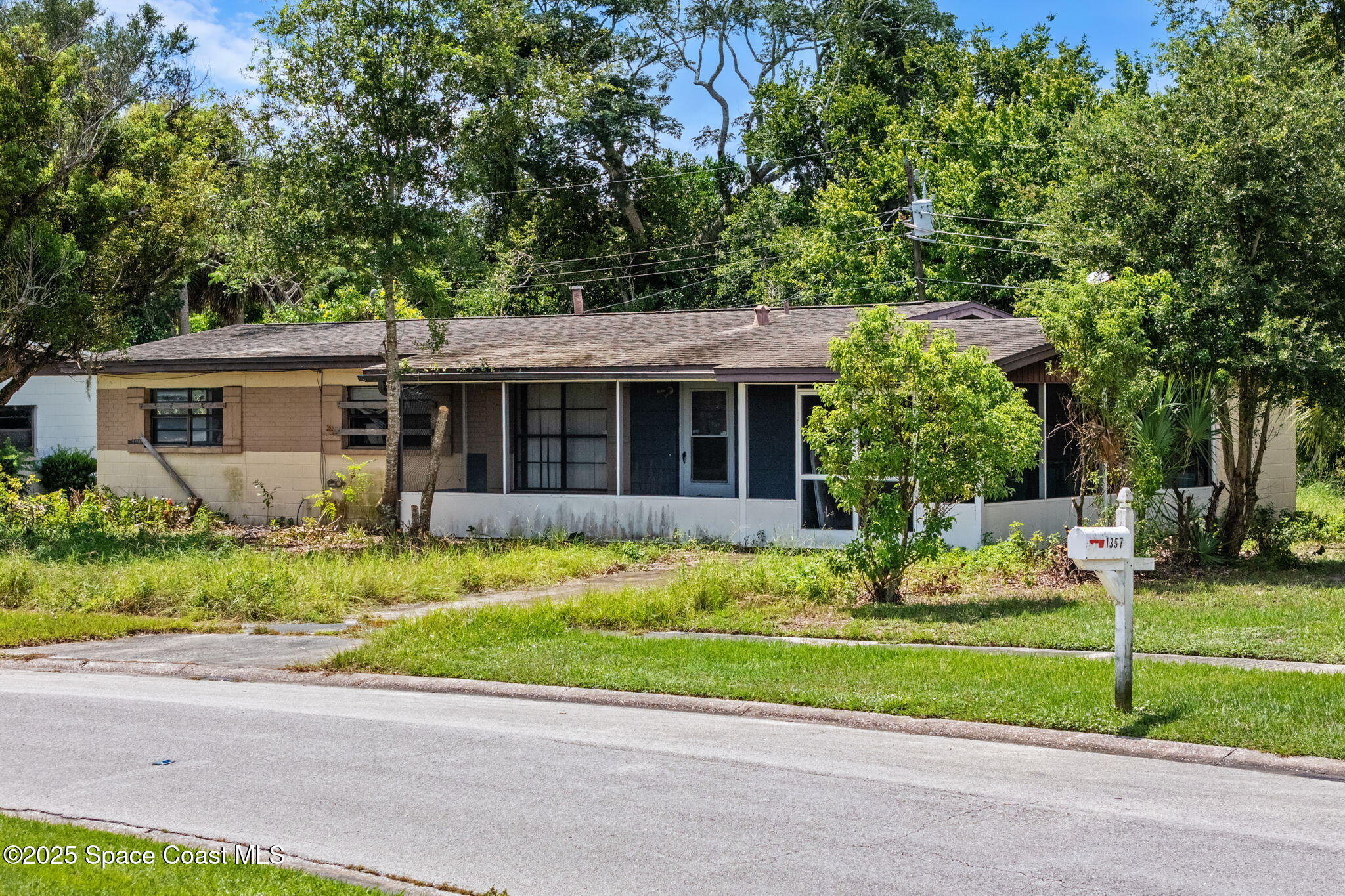 a front view of a house with a garden and plants