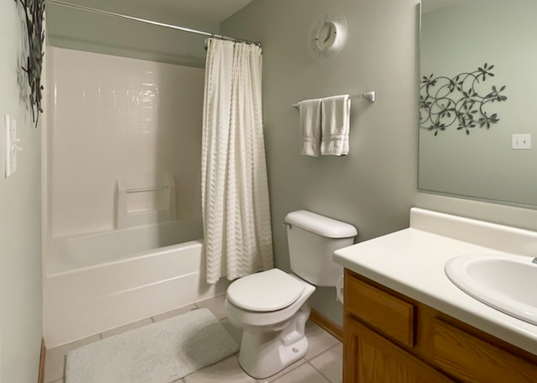 1809 Golden Gate Lane Naperville, IL 60563 - Photo 21 of 25 a white toilet sitting next to a bath tub