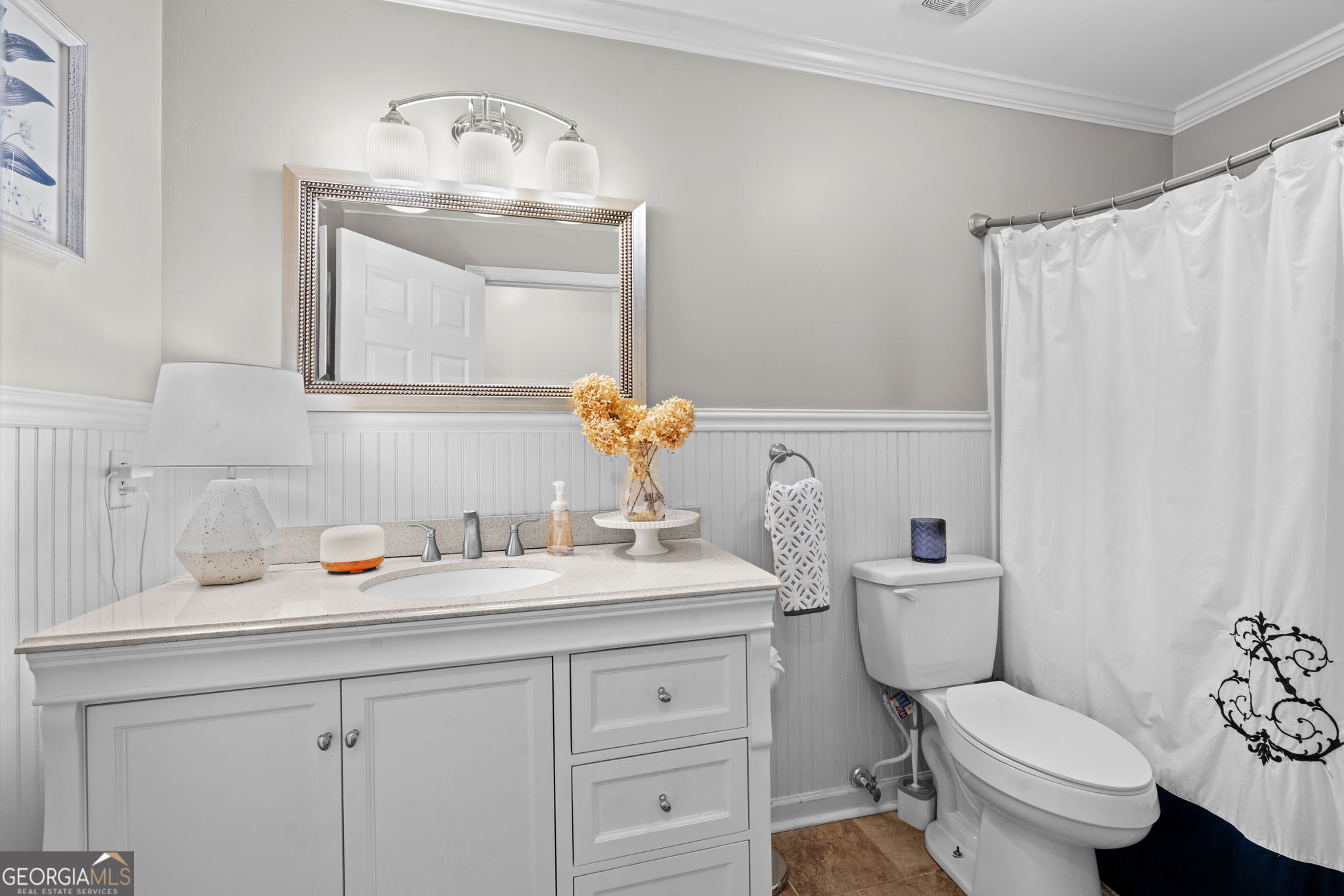 732 Bass Road Macon, GA 31210 - Photo 27 of 57 a bathroom with a toilet sink vanity and mirror