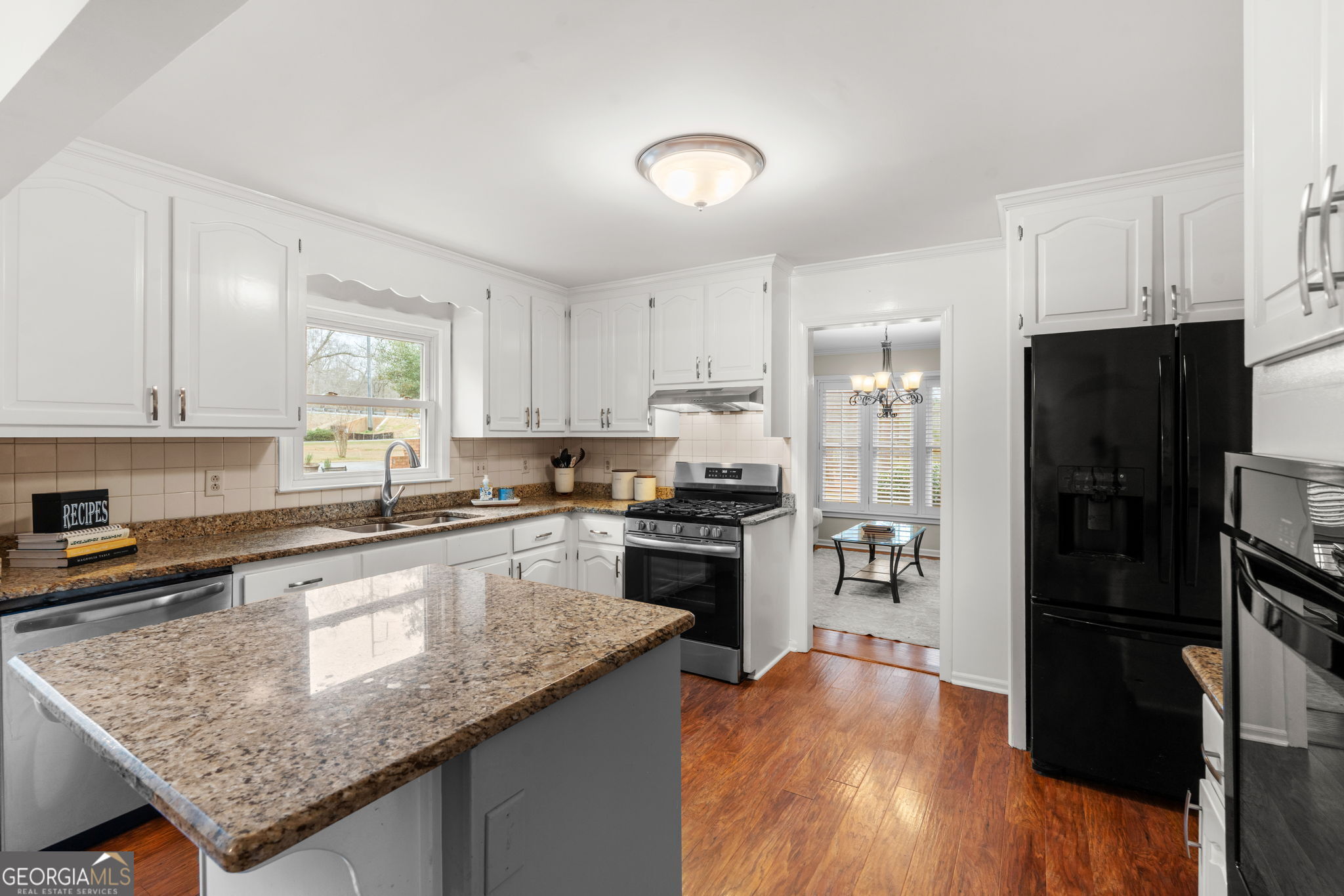 732 Bass Road Macon, GA 31210 - Photo 7 of 57 a kitchen with stainless steel appliances granite countertop a refrigerator a stove top oven a sink and dishwasher with wooden floor