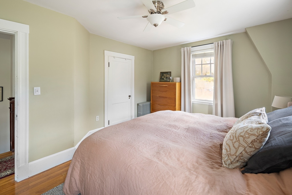 49 Cottage Street Sharon, MA 02067 - Photo 12 of 26 a bedroom with a bed and wooden floor