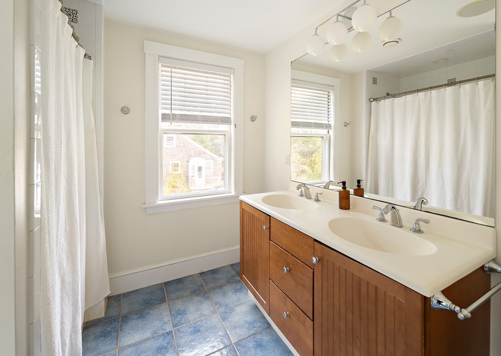 49 Cottage Street Sharon, MA 02067 - Photo 15 of 26 a spacious bathroom with double vanity and a mirror