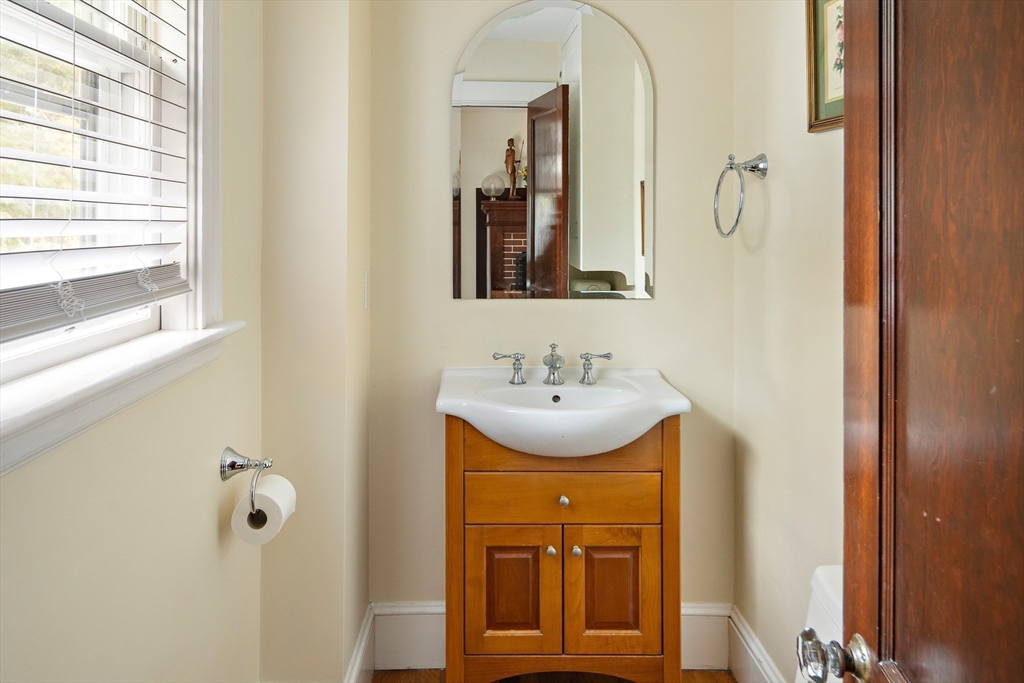 49 Cottage Street Sharon, MA 02067 - Photo 16 of 26 a bathroom with a sink a mirror and shower