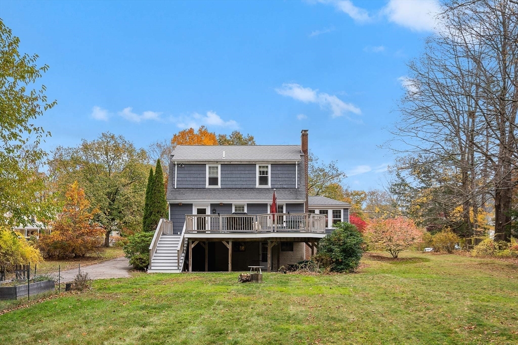 49 Cottage Street Sharon, MA 02067 - Photo 19 of 26 a front view of house with yard and trees in the background