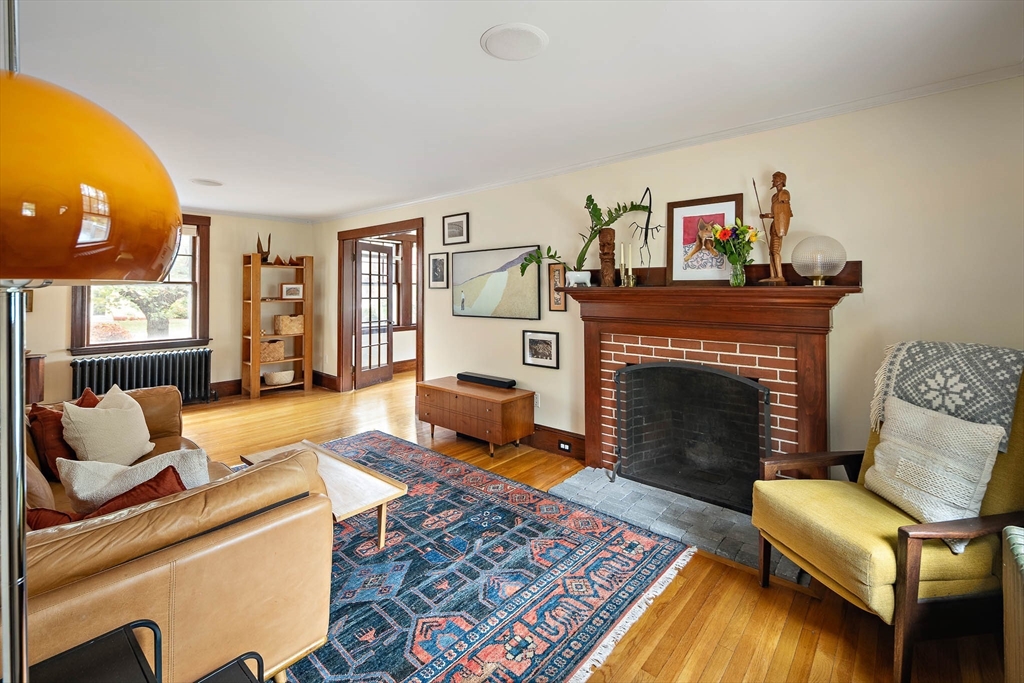 49 Cottage Street Sharon, MA 02067 - Photo 6 of 26 a living room with furniture and a fireplace