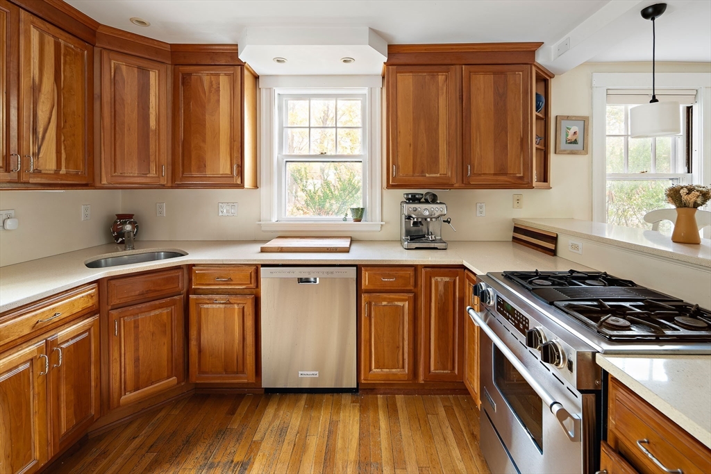 49 Cottage Street Sharon, MA 02067 - Photo 8 of 26 a kitchen with granite countertop wooden cabinets a sink and a stove