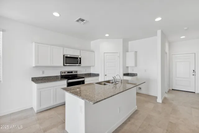 a kitchen that has a sink and a stove in it