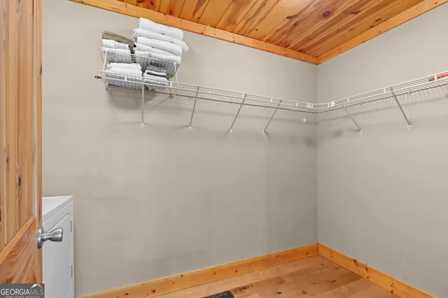 a bedroom with a bed and a table with wooden floor