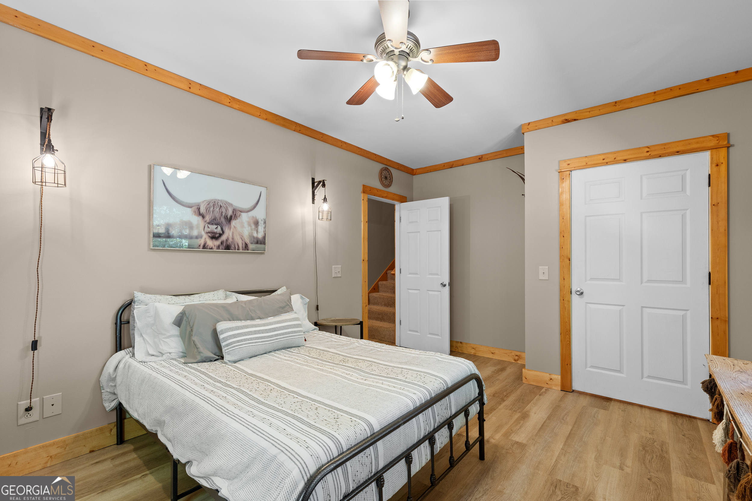 224 Dragon Tree Lane Lakemont, GA 30552 - Photo 20 of 38 a bedroom with a large bed and a chandelier