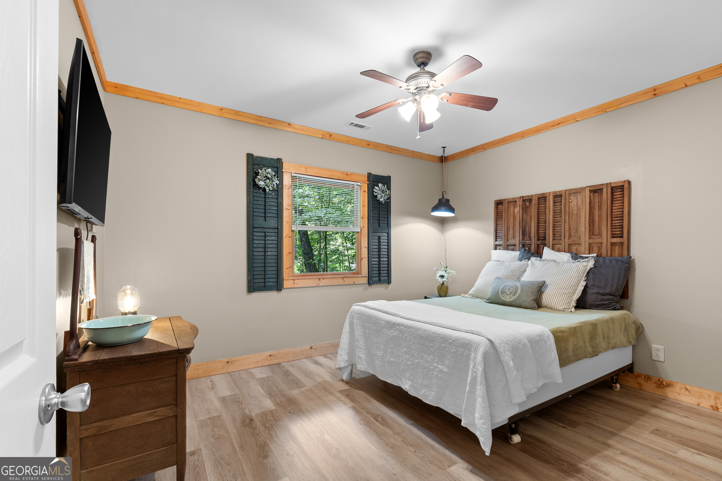 224 Dragon Tree Lane Lakemont, GA 30552 - Photo 21 of 38 a bedroom with a large bed and a chandelier