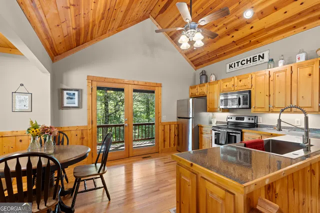 a kitchen with stainless steel appliances granite countertop a stove a sink and a refrigerator