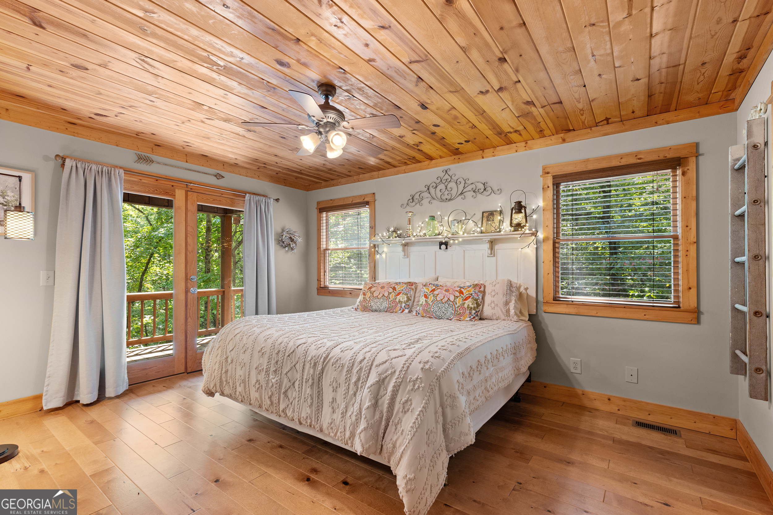 224 Dragon Tree Lane Lakemont, GA 30552 - Photo 10 of 38 a bedroom with a large bed and a large window