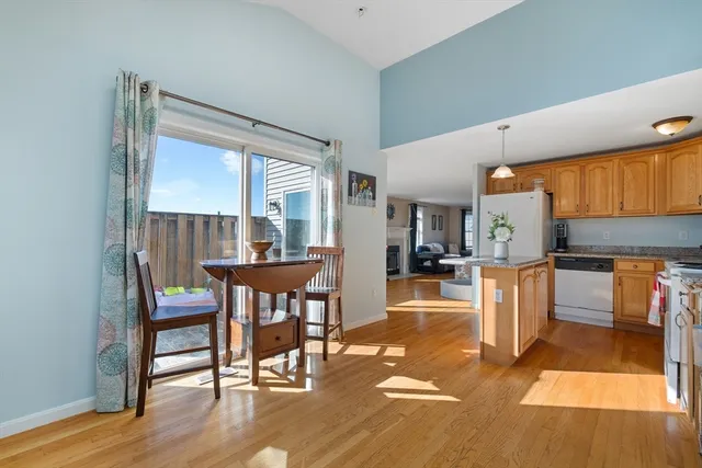 a kitchen that has a microwave a stove and a wooden floor