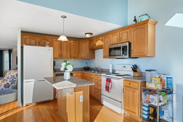 a living room with lots of furniture and kitchen view