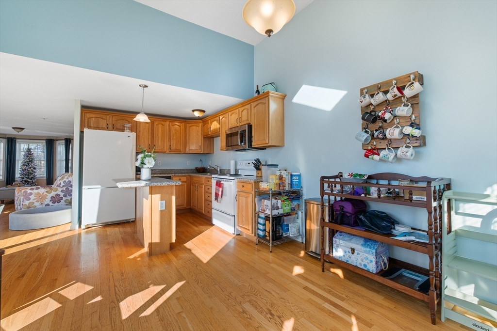 72 Sophia Drive Worcester, MA 01607 - Photo 13 of 25 a living room with lots of furniture and kitchen view