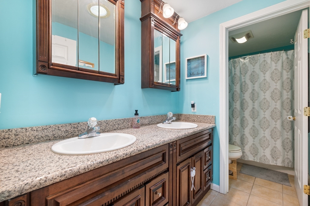 72 Sophia Drive Worcester, MA 01607 - Photo 18 of 25 a bathroom with a granite countertop sink and a mirror