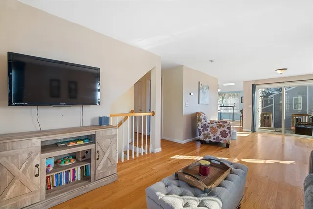 a living room with furniture fireplace and large window