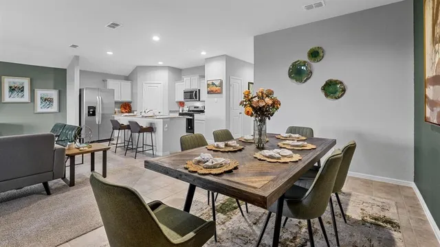 a view of a dining room with furniture and window