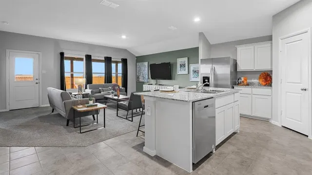 a kitchen with stainless steel appliances a refrigerator stove microwave and cabinets