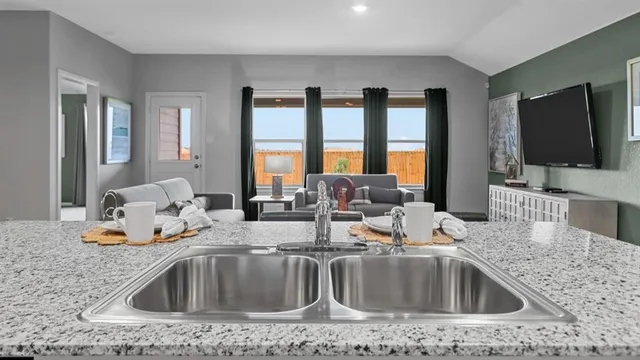 a living room with kitchen island furniture and a large window
