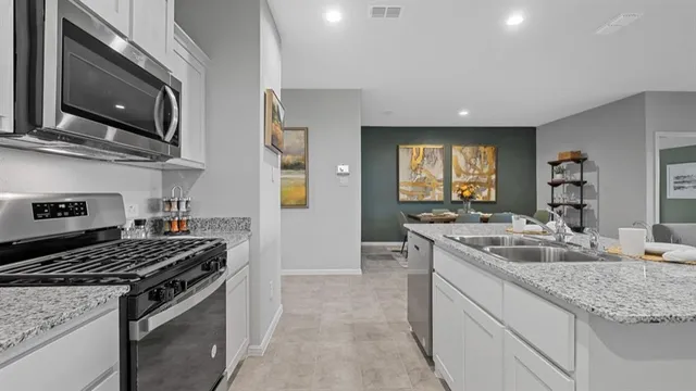 a stove top oven sitting inside of a kitchen