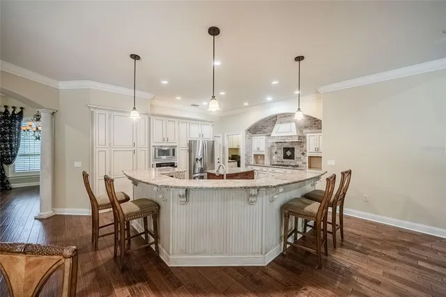 a view of a dining room and chairs with wooden floor