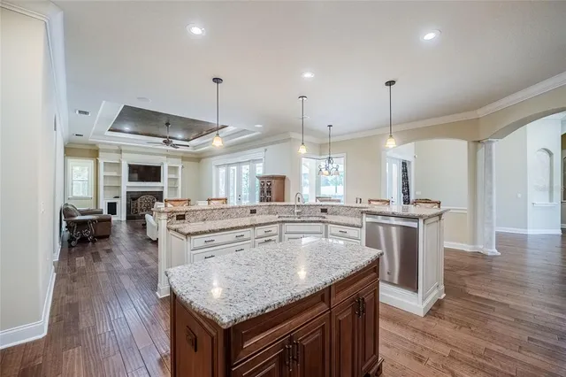 a kitchen with stainless steel appliances granite countertop a stove oven and a refrigerator
