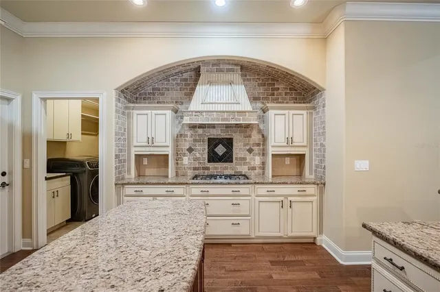 a kitchen with stainless steel appliances granite countertop a stove and a sink
