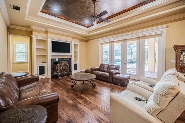 a living room with furniture a fireplace and a flat screen tv