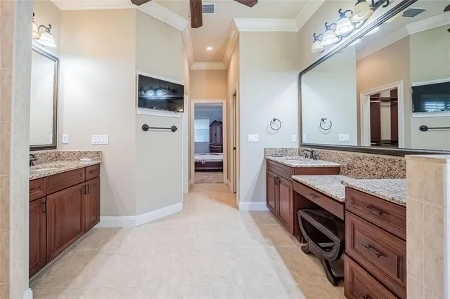 a spacious bathroom with a granite countertop double vanity sink and a mirror