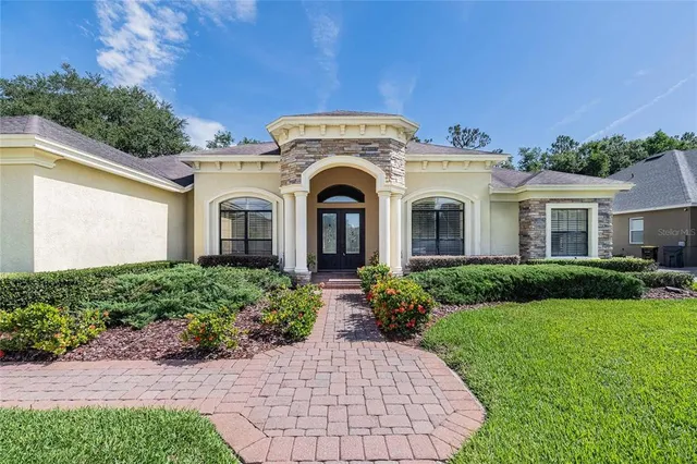 a front view of a house with garden