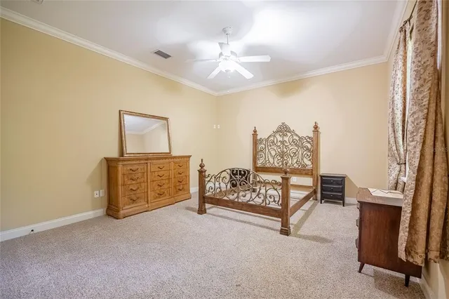 a spacious bedroom with a bed and a chandelier