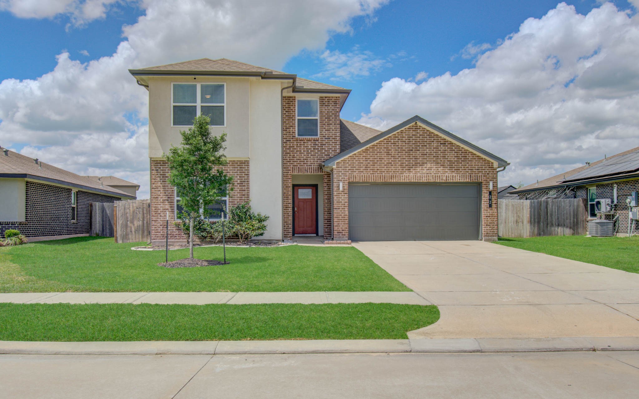 22 Desert Spring Lane Manvel, TX 77578 - Photo 1 of 36 a front view of a house with a yard and garage