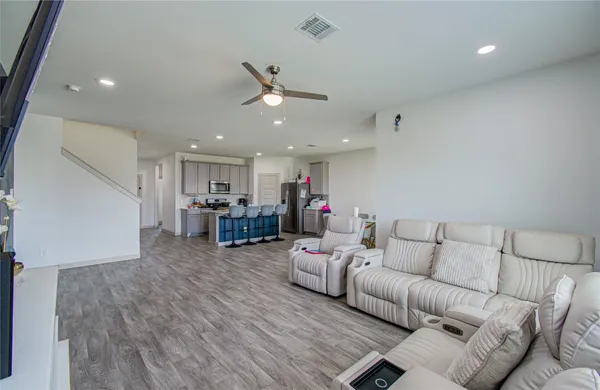a living room with furniture and kitchen view
